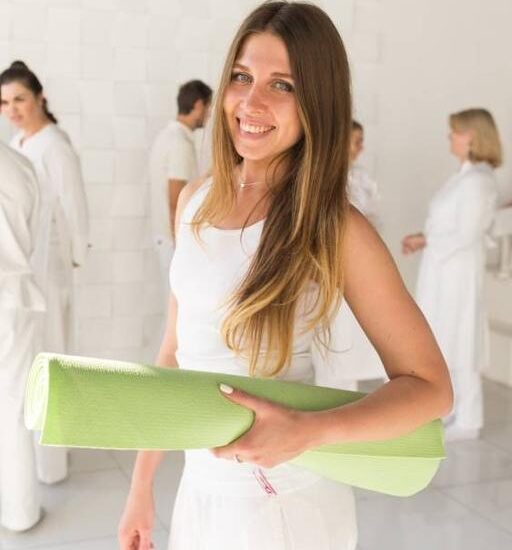 a woman holding a yoga mat